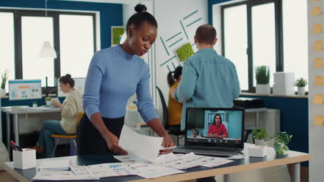 Portrait-of-african-american-business-employee-using-laptop-in-video-call-conference-with-manager