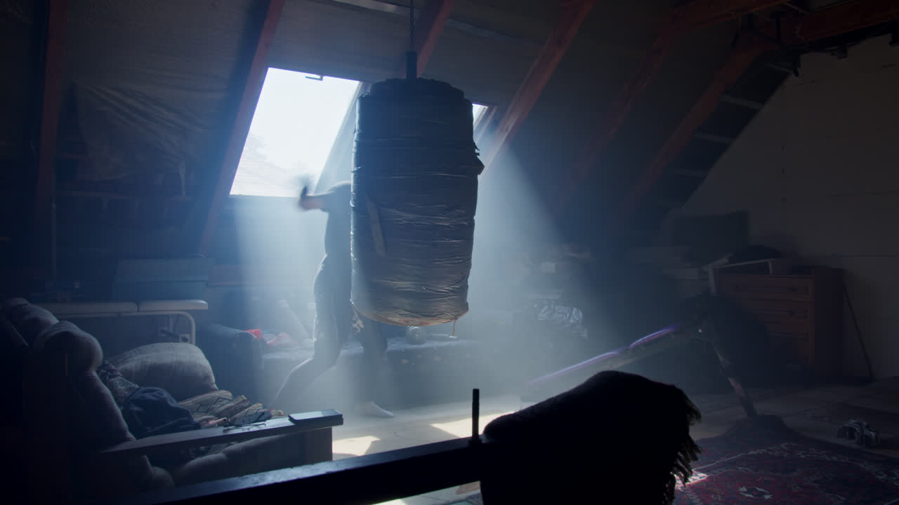 Man Boxing in Attic Gym