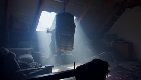 man boxing in attic gym