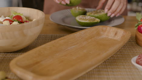 the hands of a woman setting the table for a gathering of friends