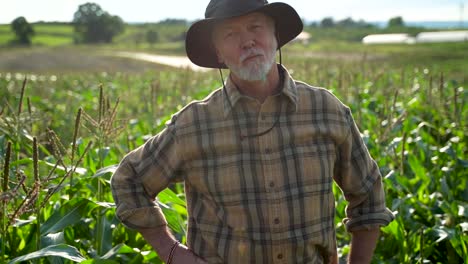 close up push in to farmer in field looking at camera at sunlight agriculture farm fharvest garden nutrition organic fresh portrait outdoor slow motion