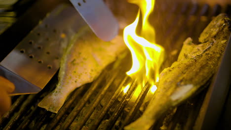 cook grilling fish in kitchen 9