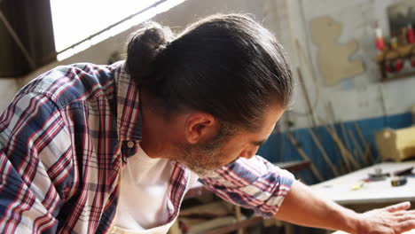 Attractive-carpenter-smiling-while-working