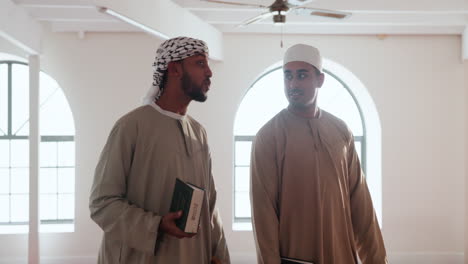 two muslim men talking in a mosque