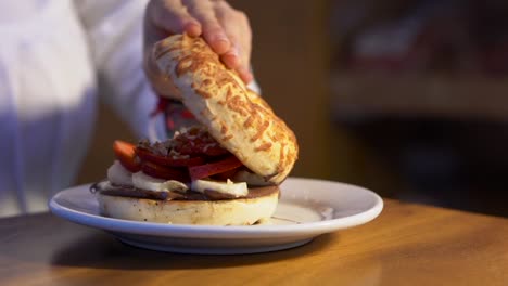 Toast-sweet-bagel-with-hazelnut-cream-fresh-banana-strawberries-closing-before-ear-woman