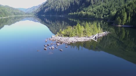 a small rugged island in a glassy mountain lake