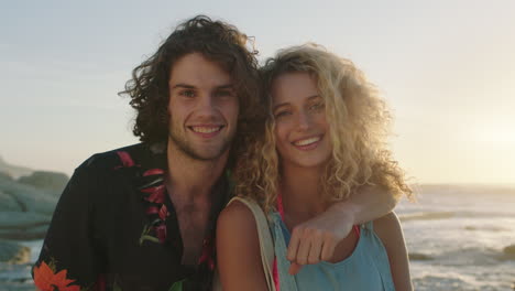 attractive couple on vacation embrace posing on beach at sunset