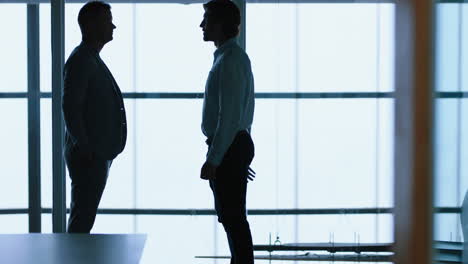 silhouette-business-people-handshake-meeting-in-corporate-office-for-partnership-deal-greeting-client-shaking-hands-welcoming-in-office-4k