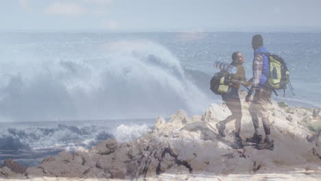 man and woman hiker standing on outcrop near ocean holding backpacks, showing animated health graph