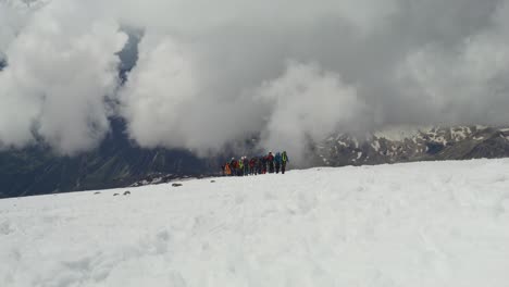 group climbing a mountain summit