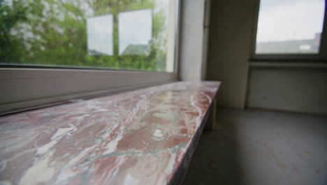 Close-up-shot-of-an-old-windowsill-in-an-empty-abandoned-house