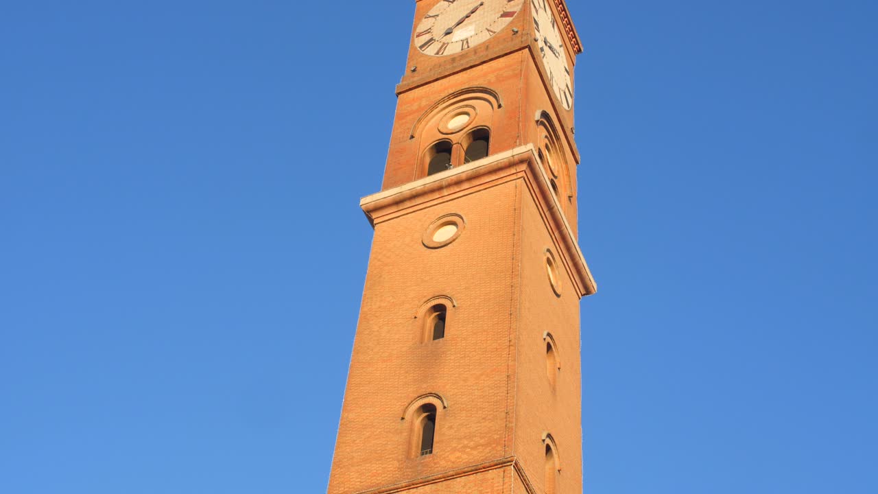 Low angle shot of Torre Civica against blue sky in Forli, Province of Forl&igrave;-Cesena, Italy on a sunny day