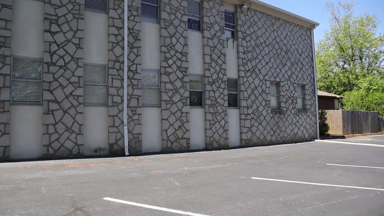 Pan of back of old church with stone walls