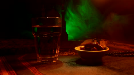 water and dates. iftar is the evening meal. slider view of decoration ramadan kareem holiday. festive greeting card, invitation for muslim holy month ramadan kareem. dark background. selective focus