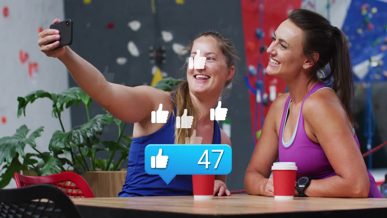 Dos mujeres haciéndose una selfie con el smartphone en el salón del gimnasio, generando noventa y cinco 'me gusta' de tecnología.