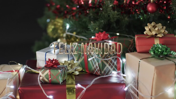 Feliz navidad text over christmas gifts, lights and tree