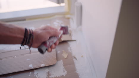 man painting wall with roller