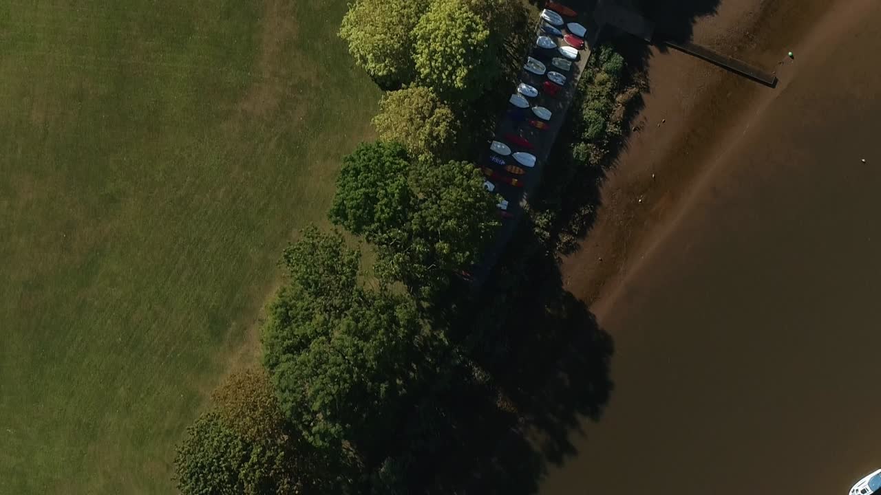 Top down of a small boat store and jetty on a low tide river