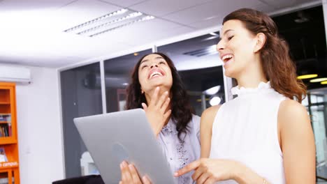 Female-executives-having-discussion-over-laptop