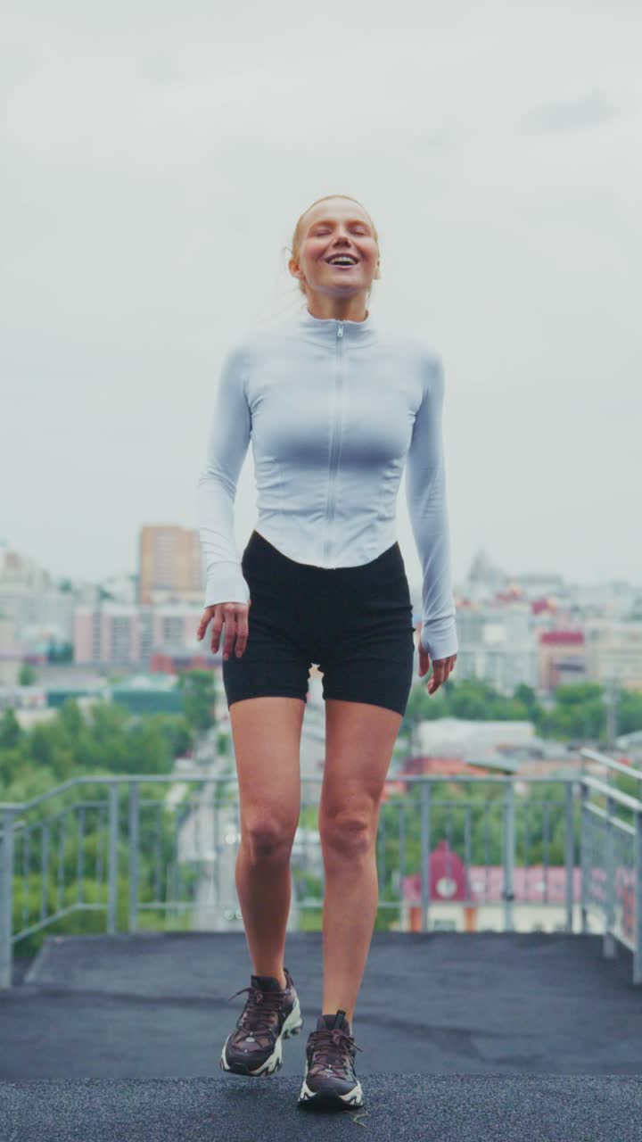 An Energetic Workout Journey: A Woman's Transformation from Running to Joyful Movement Amidst a Scenic Urban Landscape