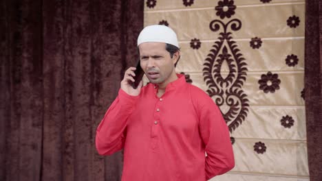 Sad-Muslim-man-talking-on-mobile-phone