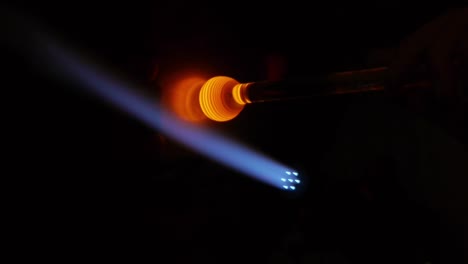 glassblowing work with a blue flame in close-up