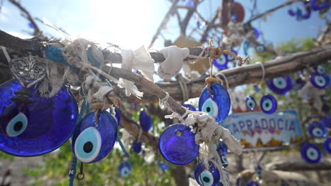 evil eye souvenirs hanging on tree, traditional handcraft from cappadocia, turkey, close up