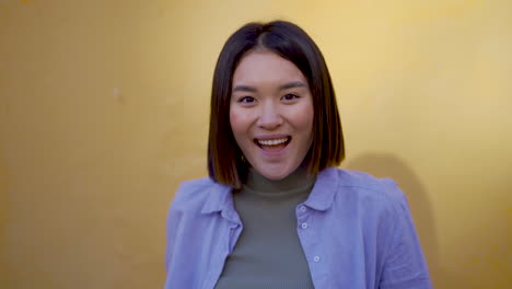 Portrait-Of-Young-Woman-Excited-And-Happy-Looking-At-Camera