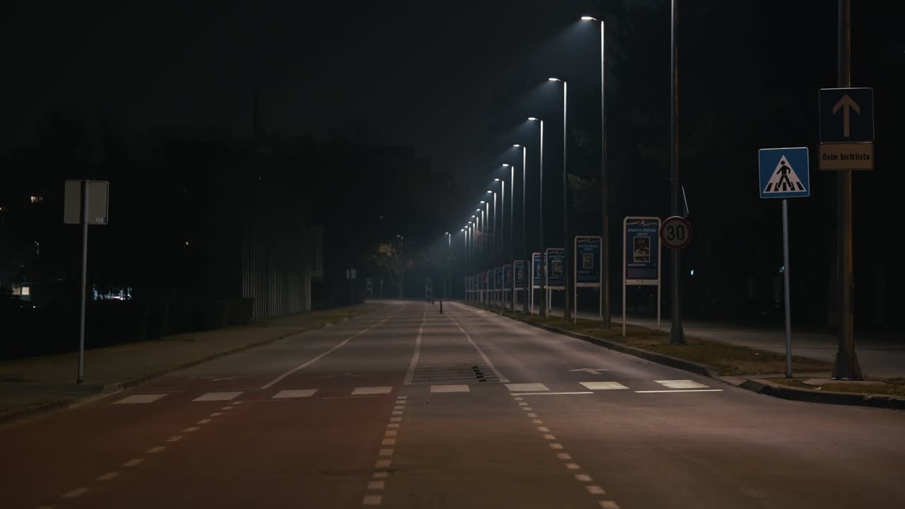 empty road lined with streetlights creates a lonely, cinematic scene in Zagreb at night