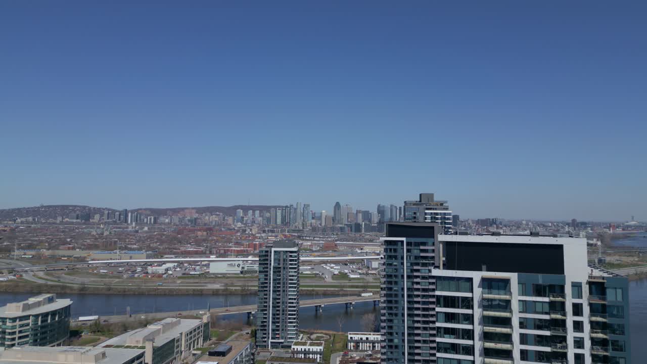 Construction Of Residential Tower With City Skyline At Nuns' Island In Montreal, Quebec, Canada. aerial upward, wide shot