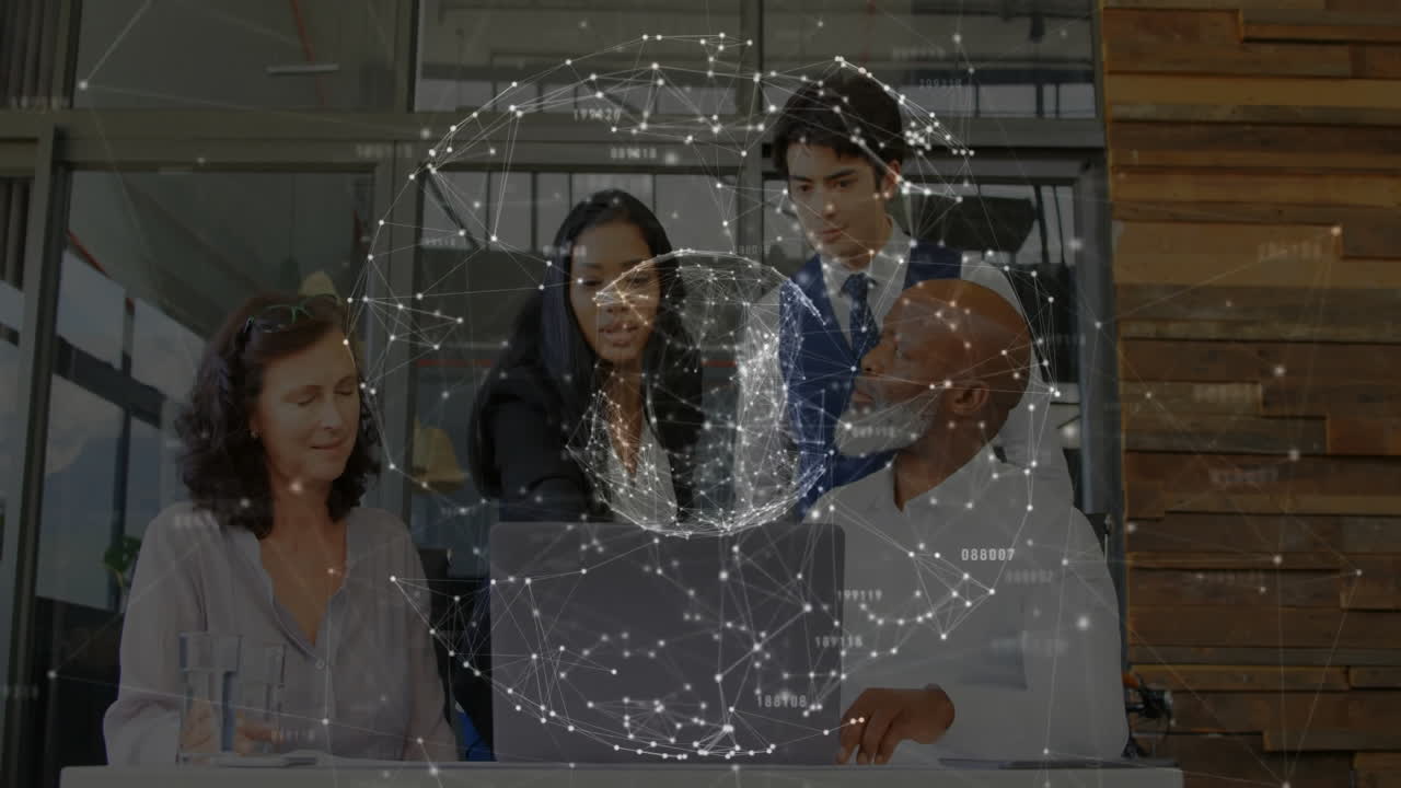 Business team collaborating around laptop in office, with network dots and lines overlaying table