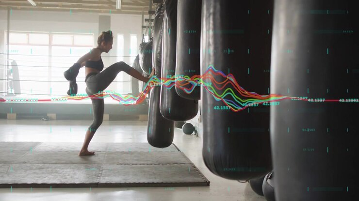 Female fitness trainee striking heavy bags in gym, waveform pulsing with each hit tracking power