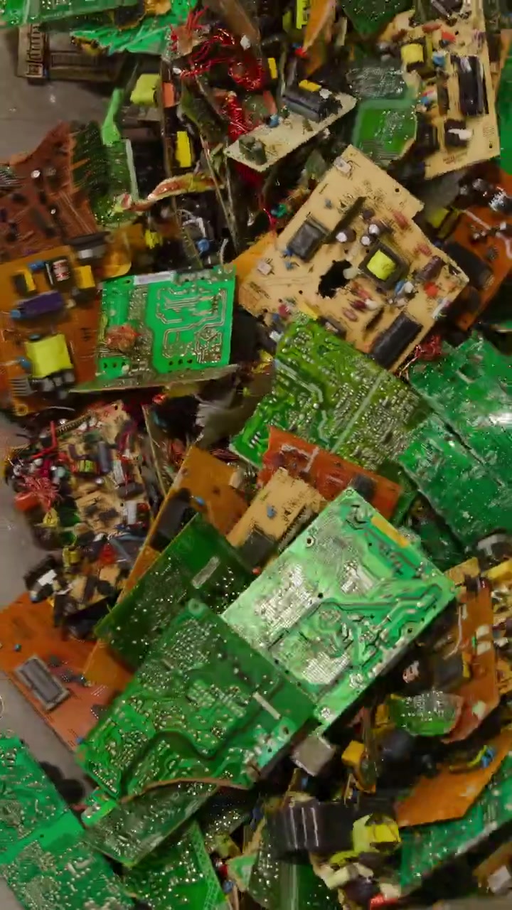 Overhead View Conveyor Of Circuit Boards In Metal Trough During Bulk Processing, Mixed Green PCBs