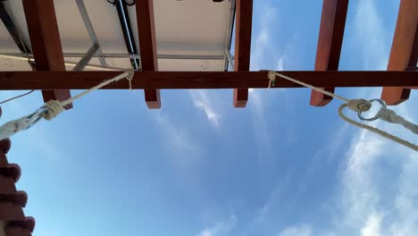 view of sky and wooden canopy of outdoor garden swing