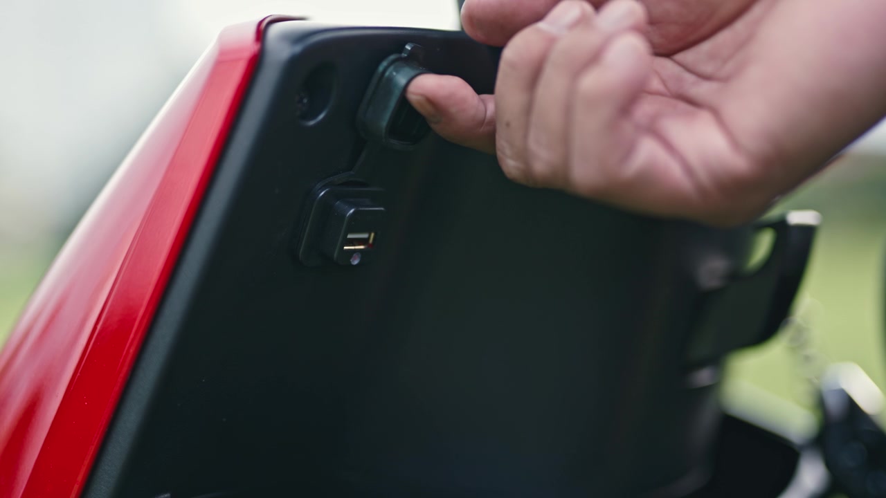 Close-up of a mobile charging hub for electric scooters, showing ports, cables, and portable power solutions supporting urban mobility.