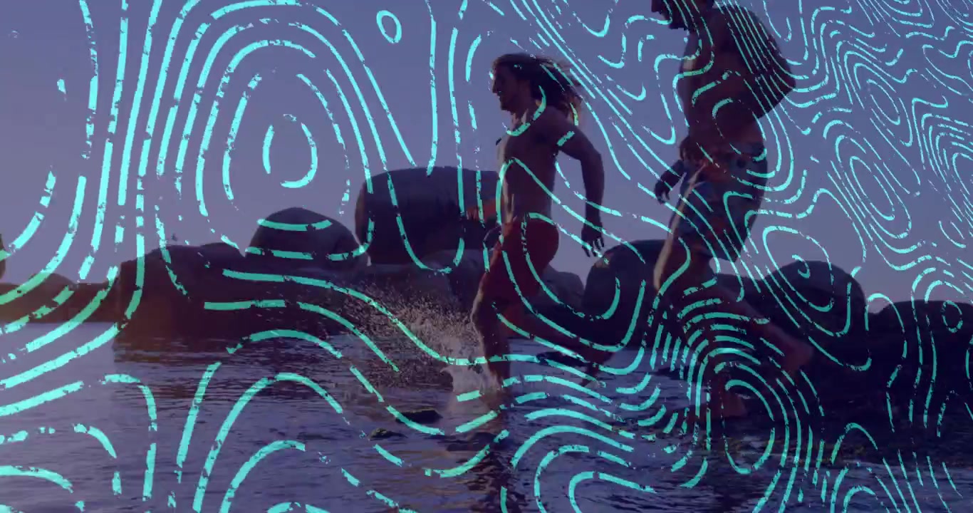 Pair walking rocky shore for travel, woman stepping into surf and creating cyan overlay splashes