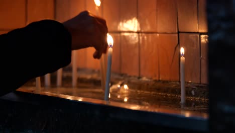 lighting candles in a church