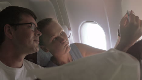 couple taking selfie in the plane