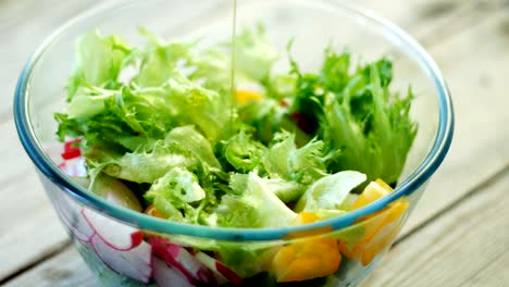 closeup - pouring dressing over salad. seamless cinemagraph looped video