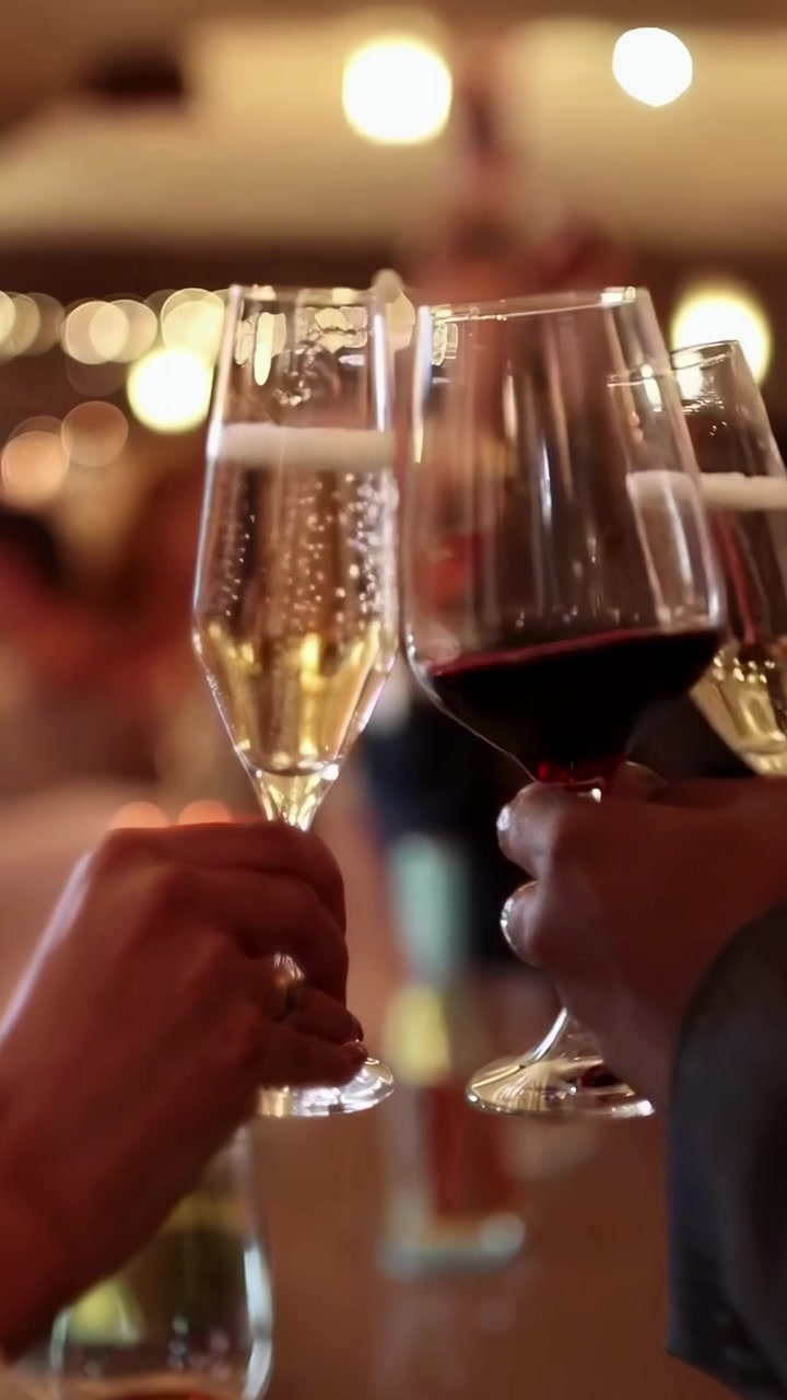 Hands Clinking Wine and Champagne Glasses in a Festive Celebration