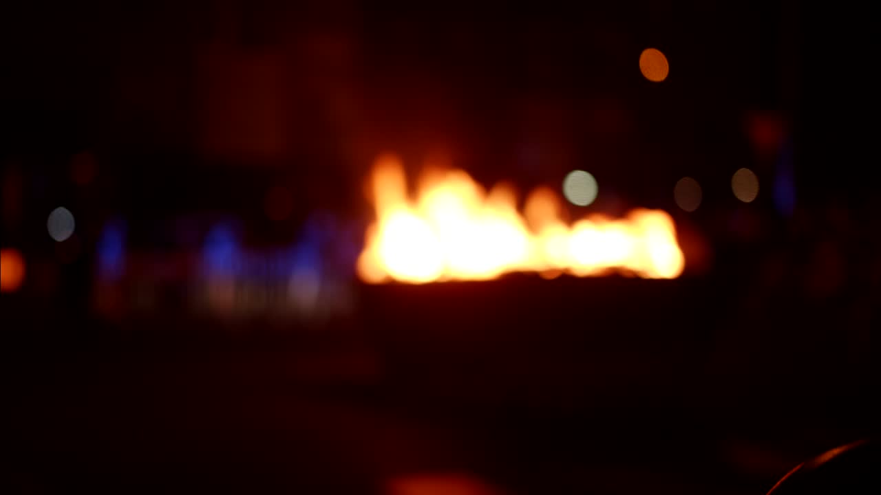 Blurred Fire and Bokeh Lights at Night with a Person