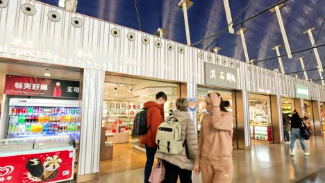 people browsing and walking past airport shop