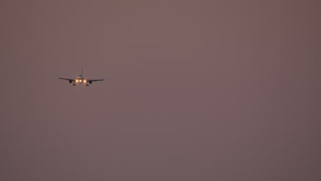 airplane landing at sunset