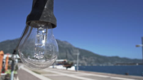 Close-up-shot-of-a-bulb-at-port-of-Kalamata-revealing-the-port-and-Targets-mountain