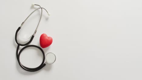 Video-of-close-up-of-stethoscope-with-heart-on-pink-background