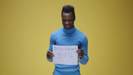 man holding 'discount 50%' sign with varying expressions