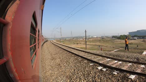 train window leaning out point of view during long distance train ride travel, indian railways