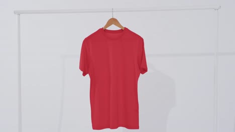 video of red t shirt on hanger and copy space on white background