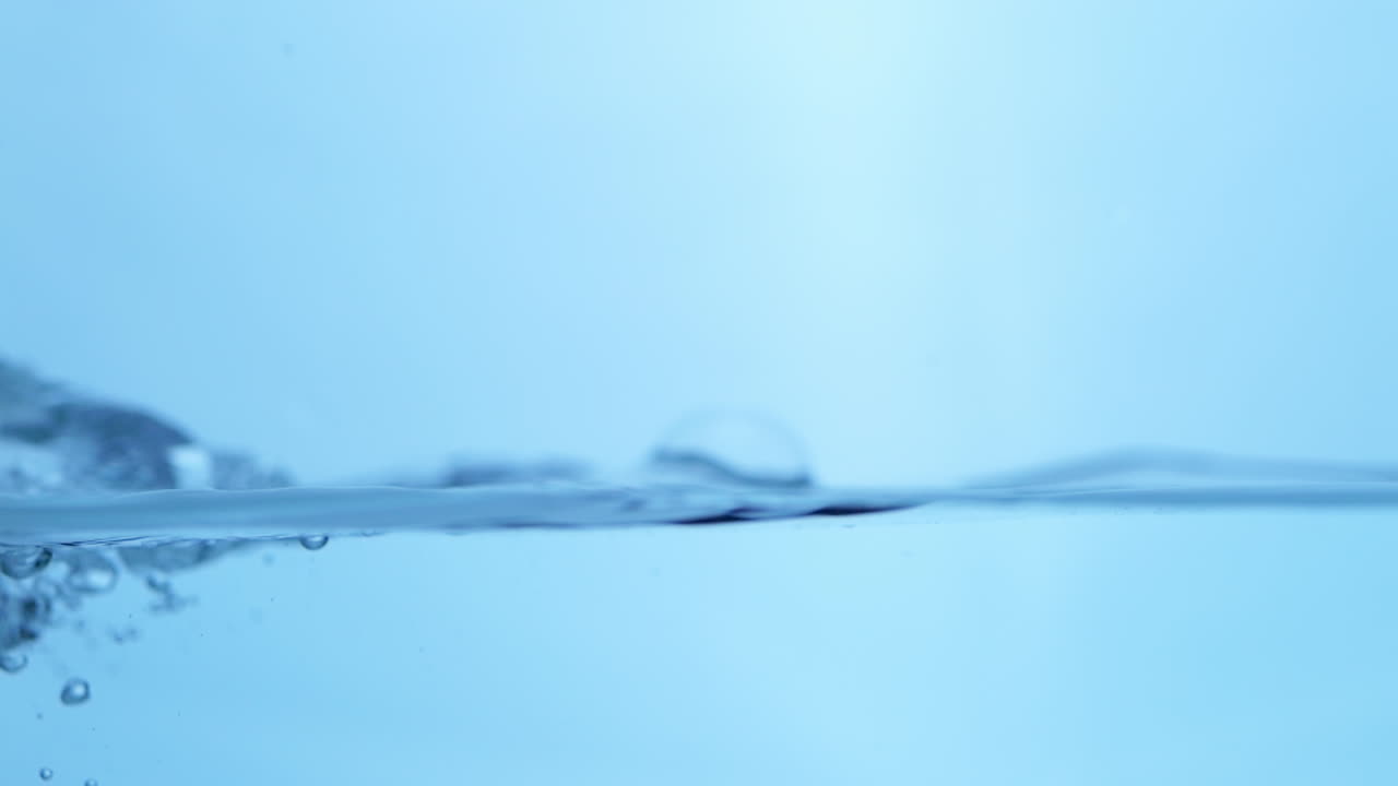 Vibrant close-up of gentle water waves, revealing the purity and refreshing qualities of nature's clean drinking water.