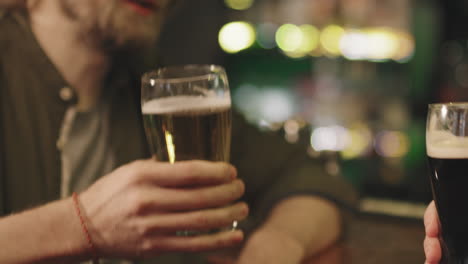 close-up of toasting beer glasses